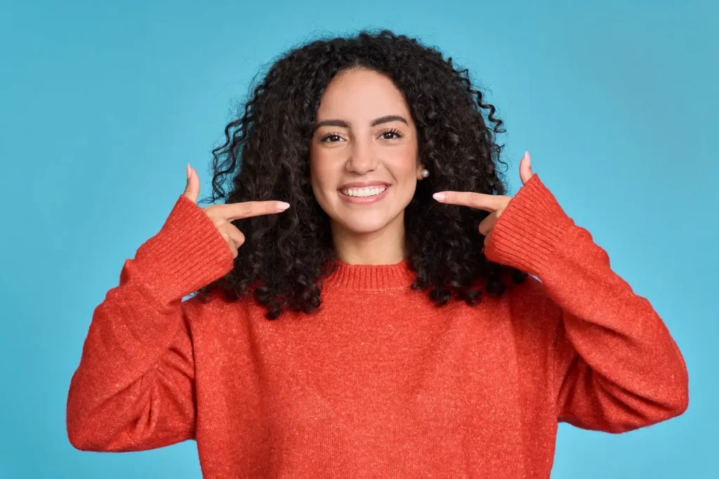 A woman smiling after a professional teeth cleaning