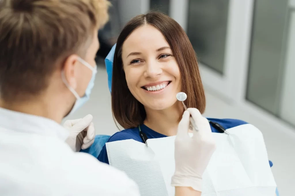 A woman smiling after cosmetic treatment at McQuary Dental