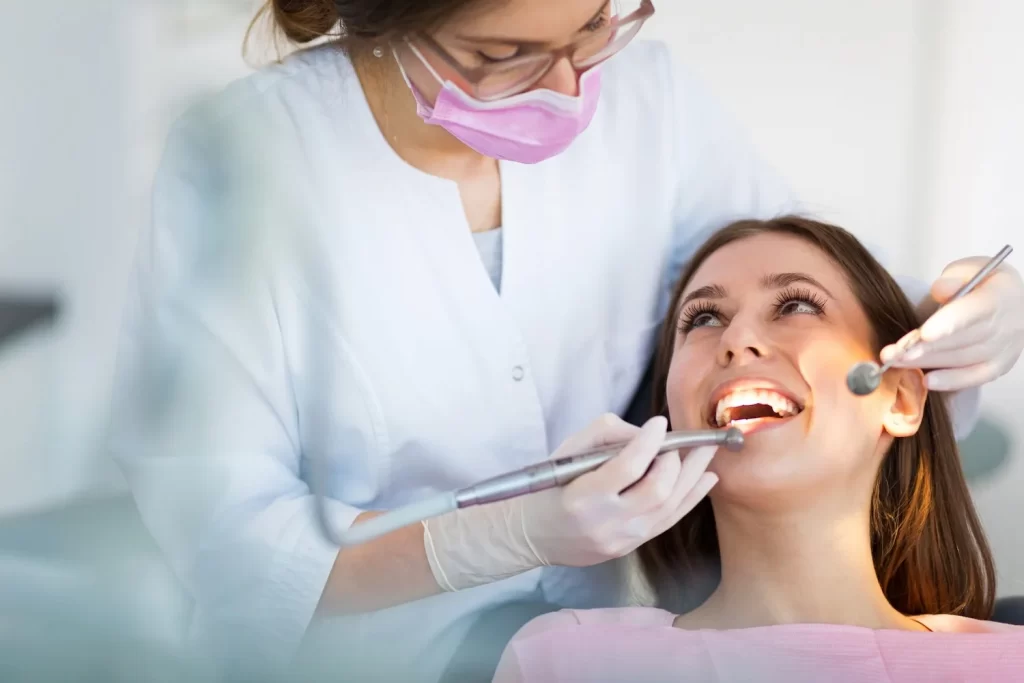 A dentist examining a patient's teeth at McQuary Dental in Tallahassee
