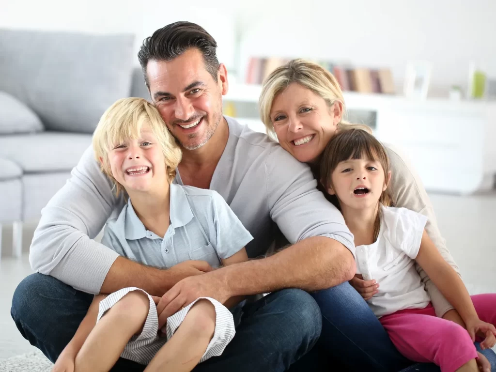 A family smiling together after a visit to McQuary Dental